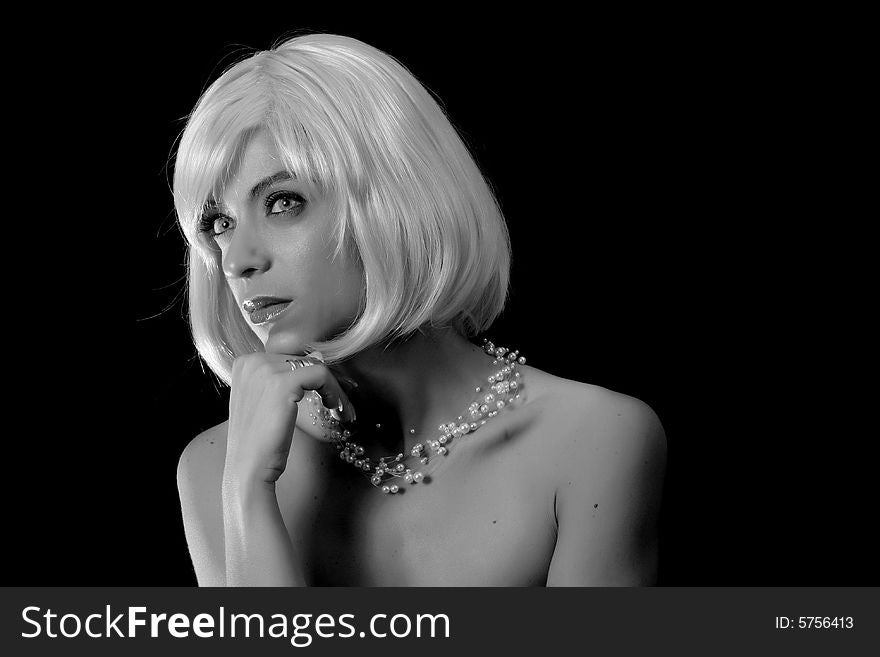 Black and white portrait of aGorgeous blond posing on black background