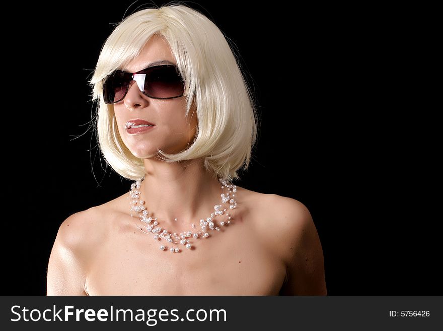 Gorgeous blond with sunglasses posing on black background. Gorgeous blond with sunglasses posing on black background