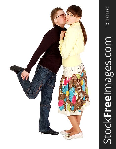 A handsome guy kisses  a girl standing on one leg, isolated on white