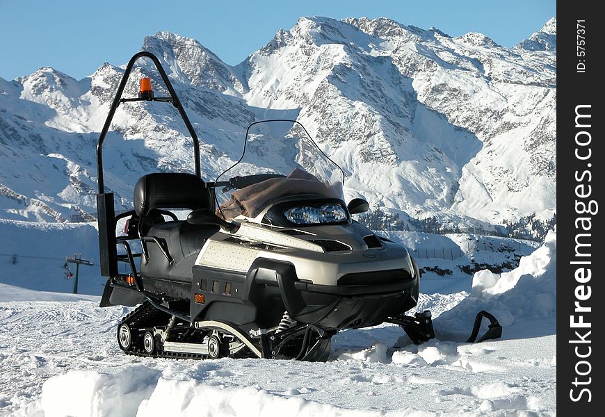 Snowmobile parked on ice mountain
