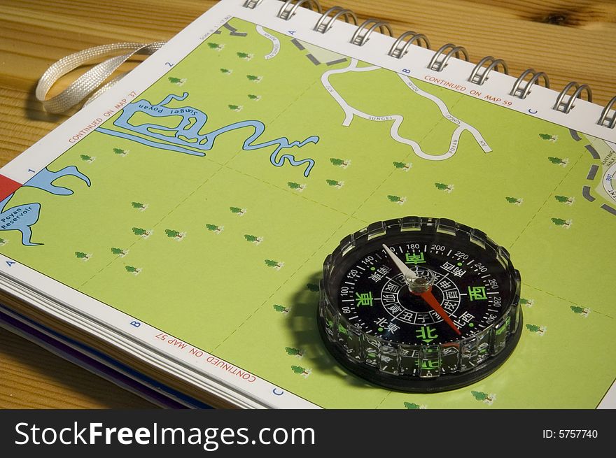 A compass on a map for navigation. A compass on a map for navigation.