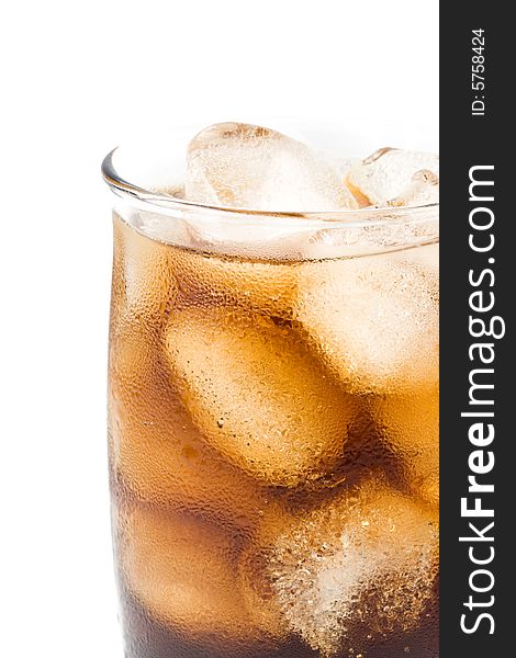 Cold fizzy cola with ice in a glass. Close up.