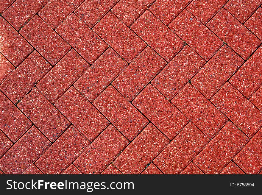 Red stones pavement with a patterned design. Red stones pavement with a patterned design