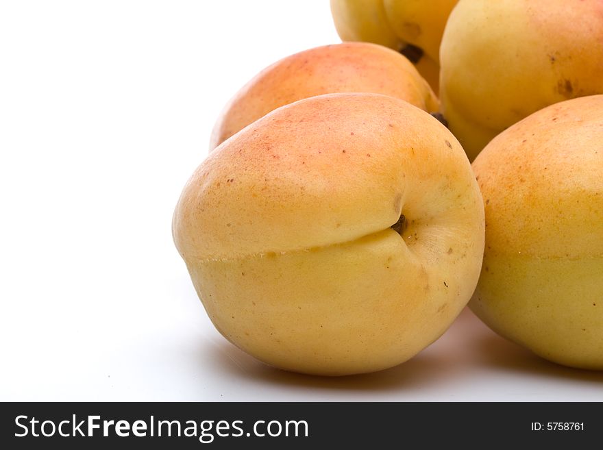 Fresh appetizing apricots on a white background. Fresh appetizing apricots on a white background