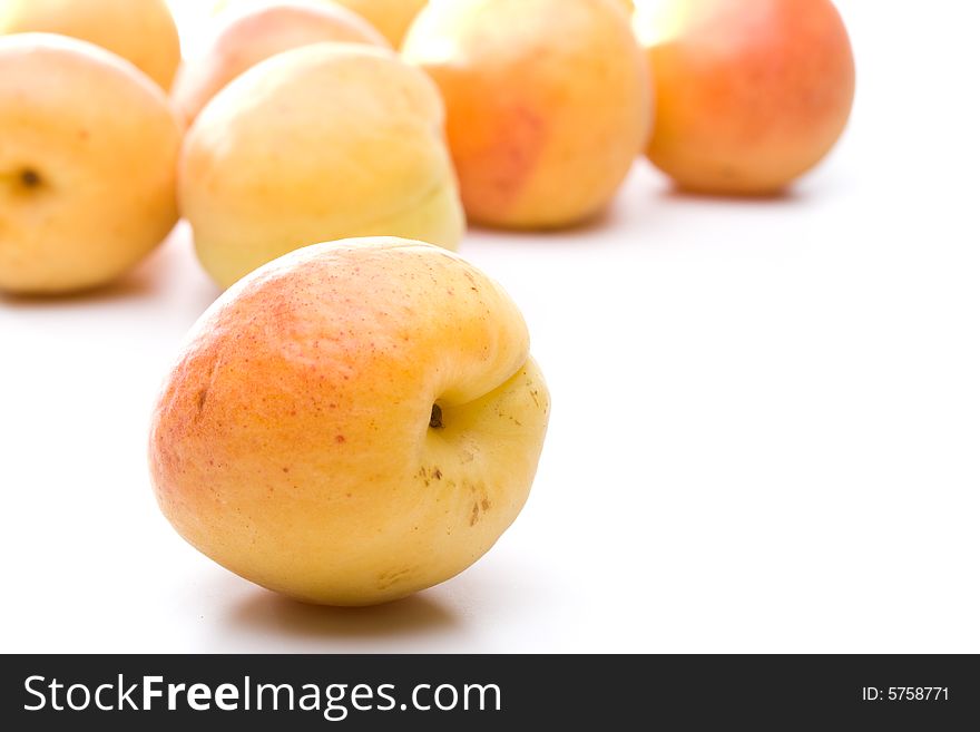 Fresh appetizing apricots on a white background. Fresh appetizing apricots on a white background