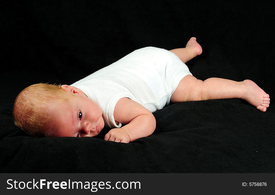 Baby boy isolated over black
