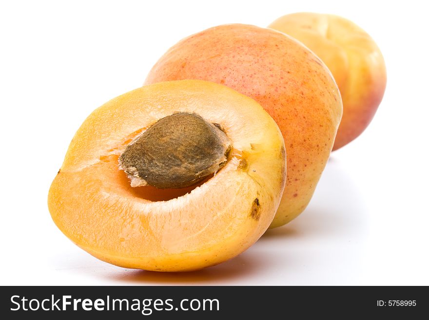 Fresh appetizing apricots on a white background. Fresh appetizing apricots on a white background
