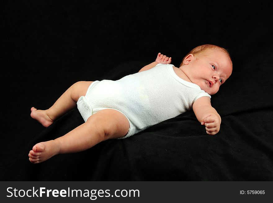 Baby boy isolated over black