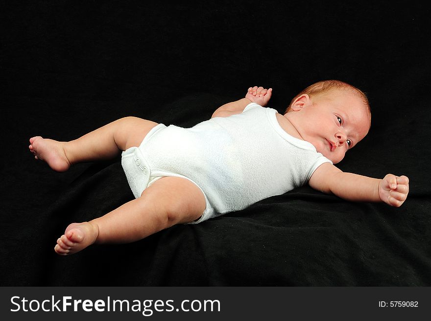 Baby boy isolated over black