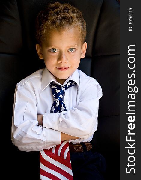 A portrait of young boy wearing US flag necktie. A portrait of young boy wearing US flag necktie