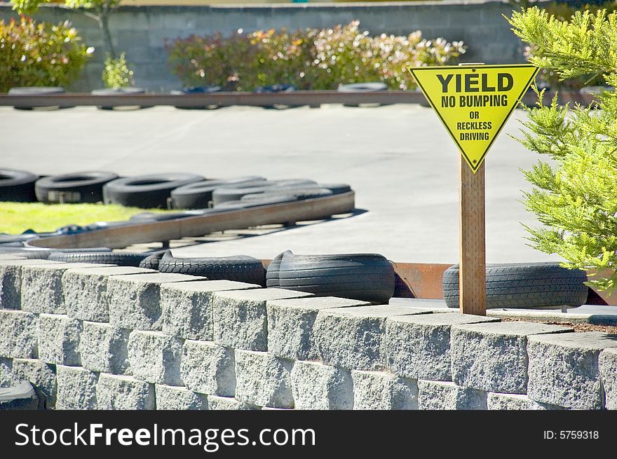 A Yield Sign warns drivers against bumping or reckless driving on a go cart track. A Yield Sign warns drivers against bumping or reckless driving on a go cart track.