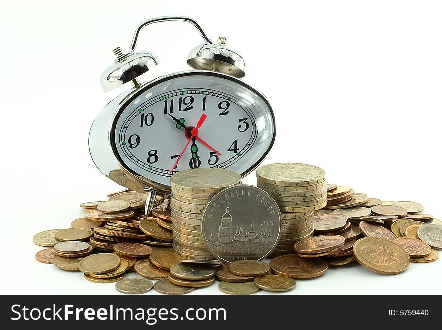 On a heap of coins of different advantage hours-alarm clocks tower. On a heap of coins of different advantage hours-alarm clocks tower