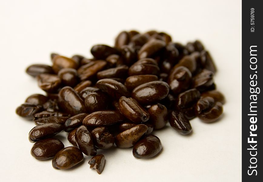 Whole coffee beans on a white background.