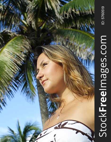 Woman with a palm tree in the background. Woman with a palm tree in the background.