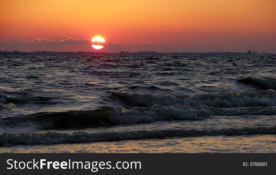 The view of a sunset on Fort Myers town beach in Florida. The view of a sunset on Fort Myers town beach in Florida.