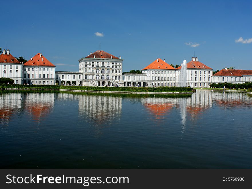 Bavarian palace with fountain and green green plantations