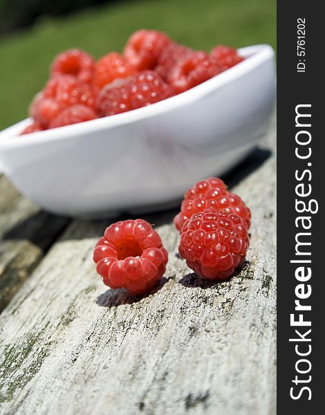 Red raspberries in white bowl