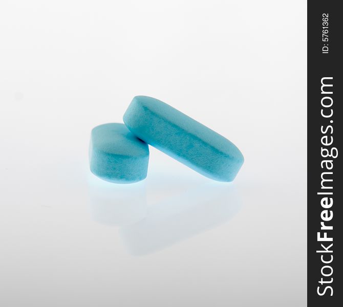 Pair of pills on white background