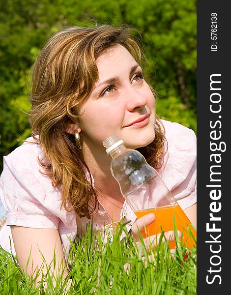 Woman Drinking Juice On The Summer Glade