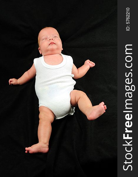 Baby boy isolated over black