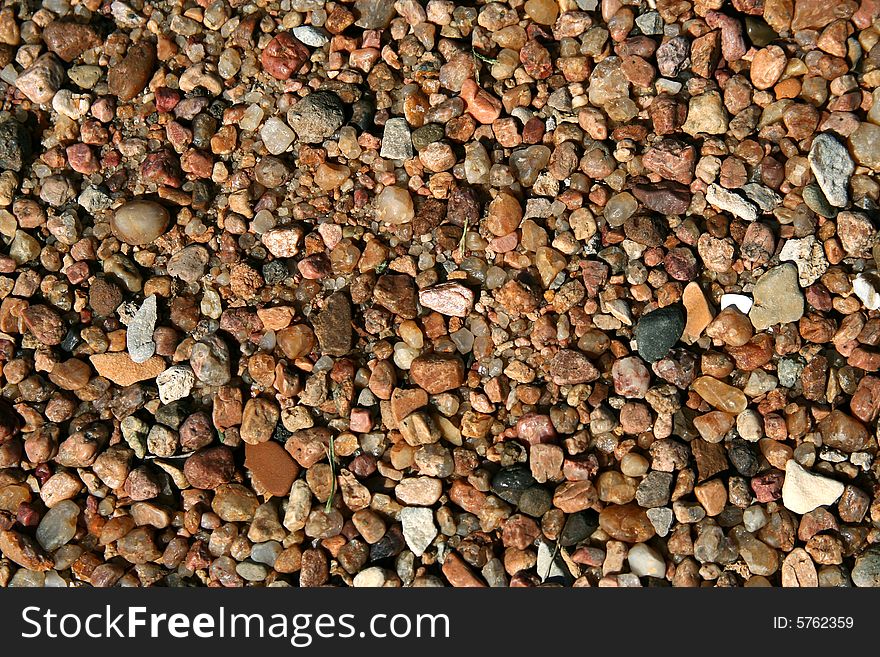 A cluster of pebbles forms an abstract background. A cluster of pebbles forms an abstract background.