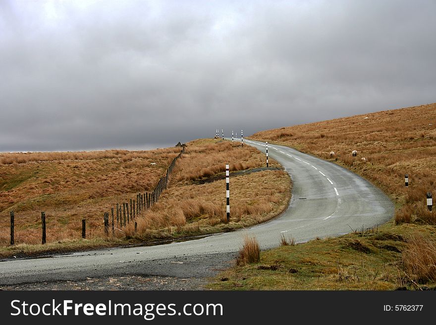 Sweeping road over the Pennine moors on a wet and grey day. Sweeping road over the Pennine moors on a wet and grey day