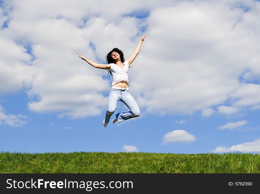 Expressive young woman is jumping