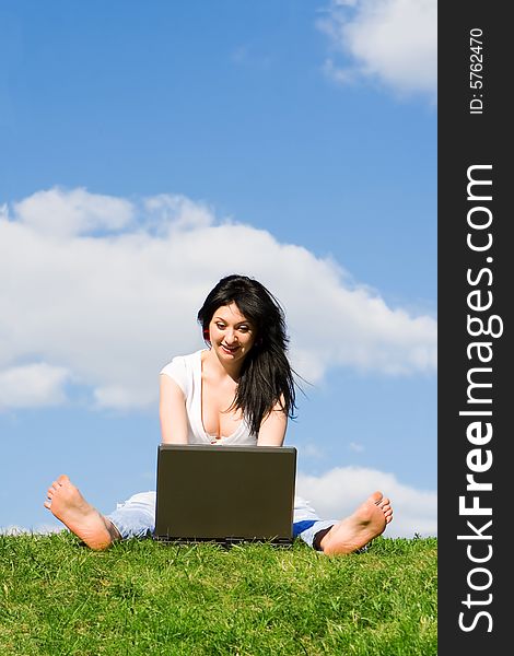 Woman With Laptop On The Green Grass