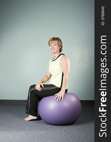 Woman Sitting on an Exercise Ball