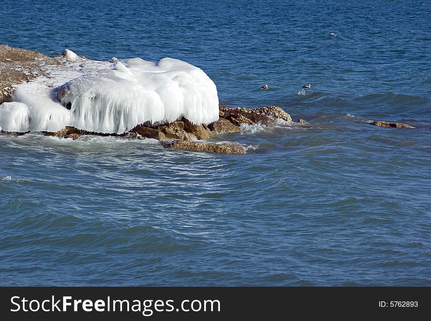 Ice island in Ontario lake in winter evening. Ice island in Ontario lake in winter evening.