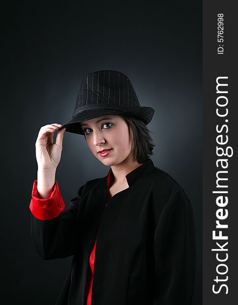 Pretty teen in black and red wearing a top hat. Pretty teen in black and red wearing a top hat
