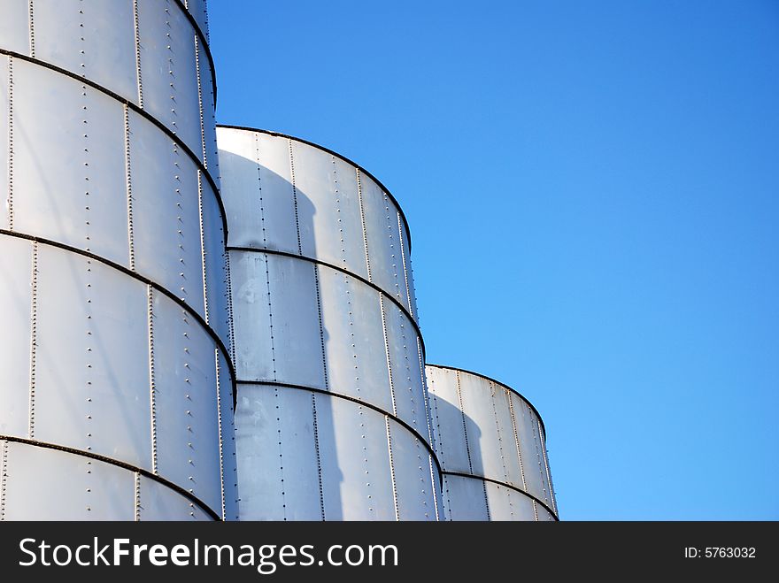 Metal silos in front of sky