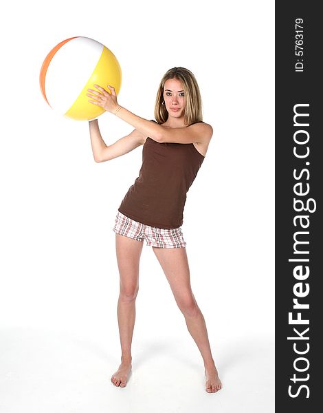 Fit and slender teenage girl holding beach ball. Fit and slender teenage girl holding beach ball