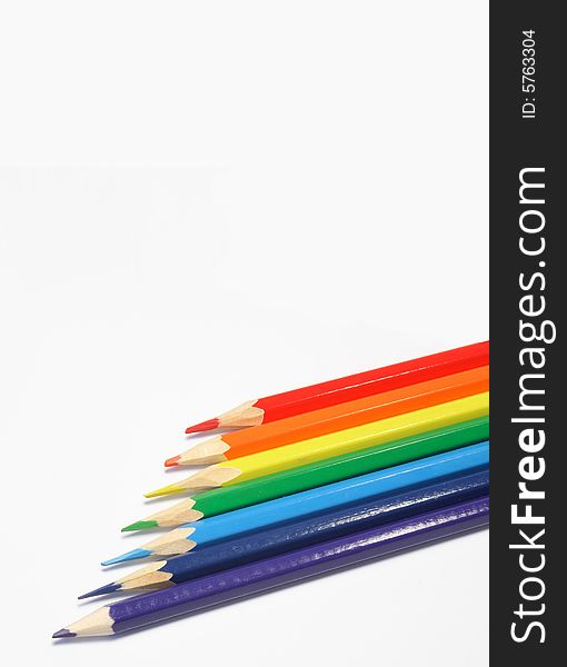 Pencils of red, green, blue, yellow, orange color on a light background. Pencils of red, green, blue, yellow, orange color on a light background.