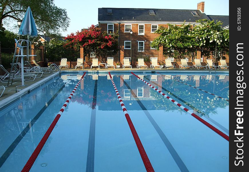 Photo of swimming pool in the early morning hours before opening. Photo of swimming pool in the early morning hours before opening.