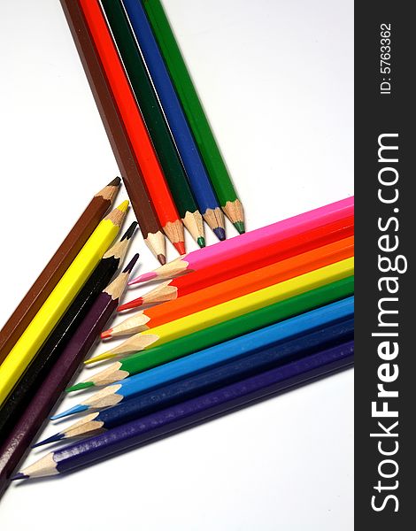 Pencils of red, green, blue, yellow, orange color on a light background. Pencils of red, green, blue, yellow, orange color on a light background.