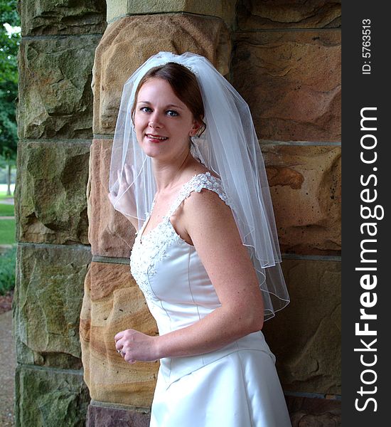 View of bride on stone porch. View of bride on stone porch