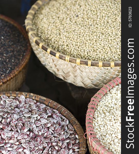 Assortment of beans and seeds in baskets at a market. Photo taken in Hanoi, Vietnam. Shallow depth of field with the seeds in the front in focus. Assortment of beans and seeds in baskets at a market. Photo taken in Hanoi, Vietnam. Shallow depth of field with the seeds in the front in focus.