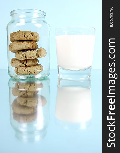 Milk and cookies isolated against a blue background