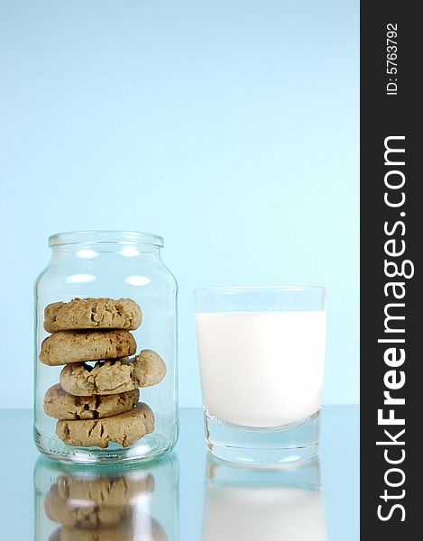 Milk and cookies isolated against a blue background