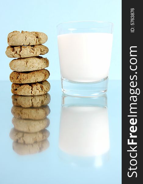 Milk and cookies isolated against a blue background