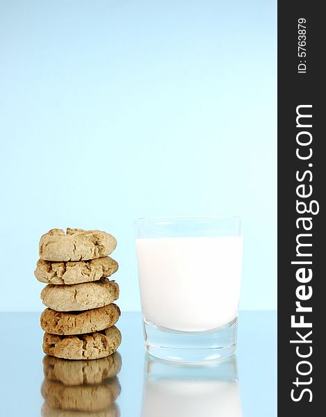 Milk and cookies isolated against a blue background