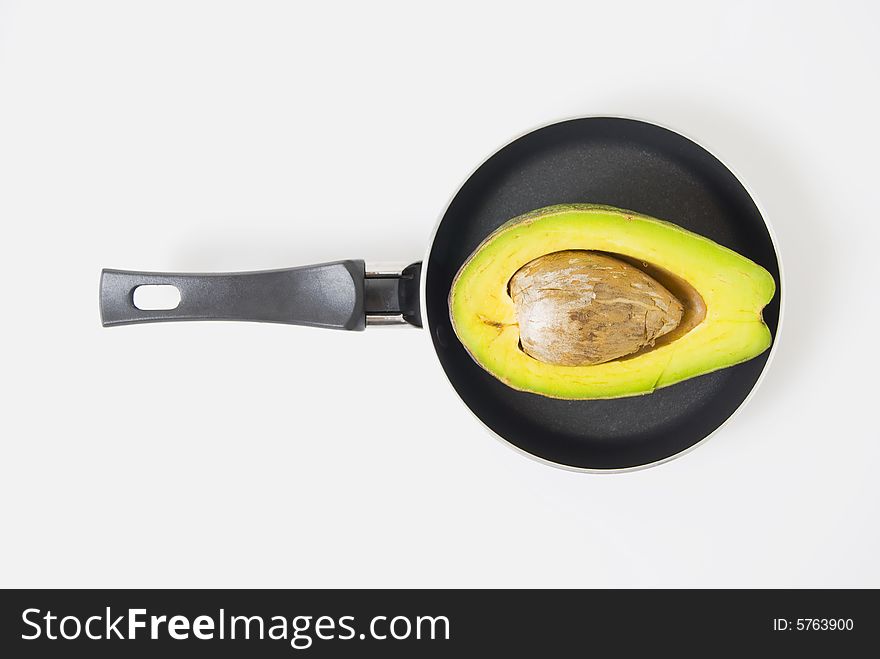 Half avocado on teflon pan