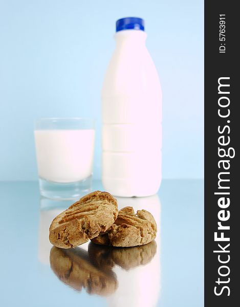 Milk and cookies isolated against a blue background