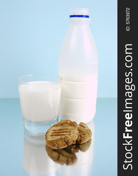 Milk and cookies isolated against a blue background