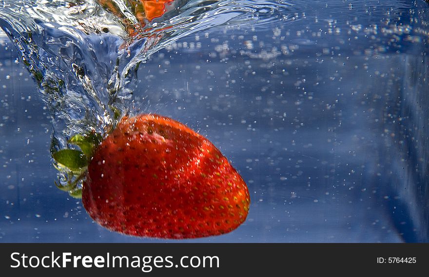 Fresh Strawberry splashing into water. Fresh Strawberry splashing into water