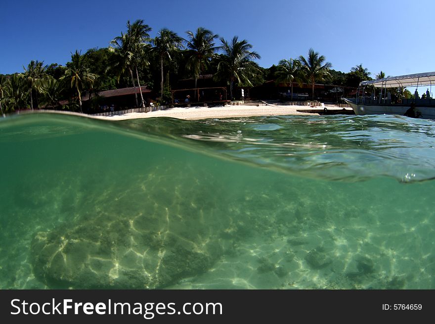 Over / under view of tropical beach