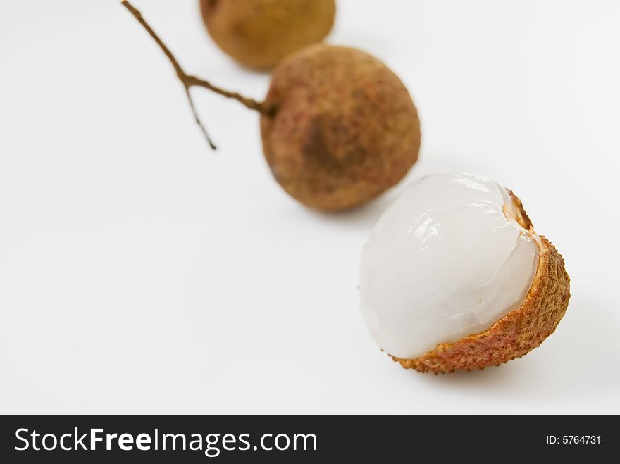 Line of Lychees on white background