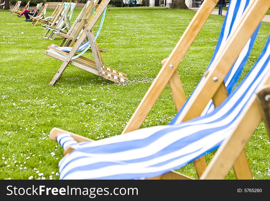 Empty deck chairs at St Jameï¿½s London Park. Focus on the second pair of chairs. Empty deck chairs at St Jameï¿½s London Park. Focus on the second pair of chairs.