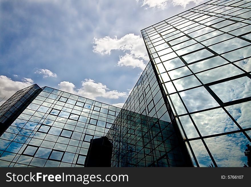 Reflecting office building with a nice cloudy sky.